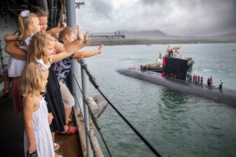 Families wave as USS Jefferson City (SSN 759) returns to Naval Base Guam.