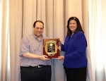 man and woman holding award plaque
