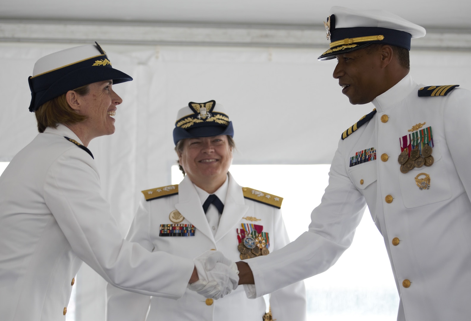 U.S. Coast Guard Cmdr. Jonathan Harris, right, relieves Capt. Anne O’Connell, left, as commanding officer of the USCGC Campbell (WMEC 909) during a change of command ceremony, June 9, 2023, at Naval Station Newport. Rear Adm. Laura Dickey, middle, deputy commander of Coast Guard Atlantic Area, presided over the ceremony. (U.S. Coast Guard photo by Petty Officer 2nd Class Eric Desirey)