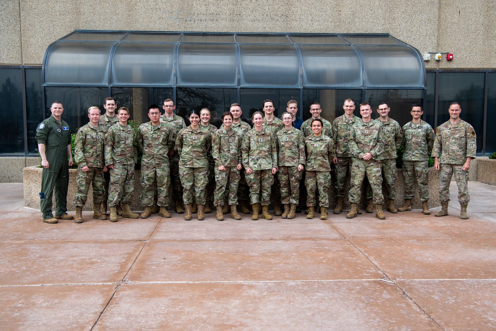 Military members in uniform pose for a group photo