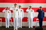 Vice Adm. Kevin Lunday, Coast Guard Atlantic Area Commander, oversees Rear Adm. Brendan McPherson, the former Seventh District Commander, and Rear Adm. Douglas Schofield, the Seventh District Commander, render a salute during a change of command ceremony at Air Station Miami in Opa-locka, Florida, June 9, 2023. During the ceremony Schofield relieved McPherson as the Seventh District Commander and Director of Department of Homeland Security Joint Task Force - Southeast. (U.S. Coast Guard photo by Petty Officer 3rd Class Eric Rodriguez)