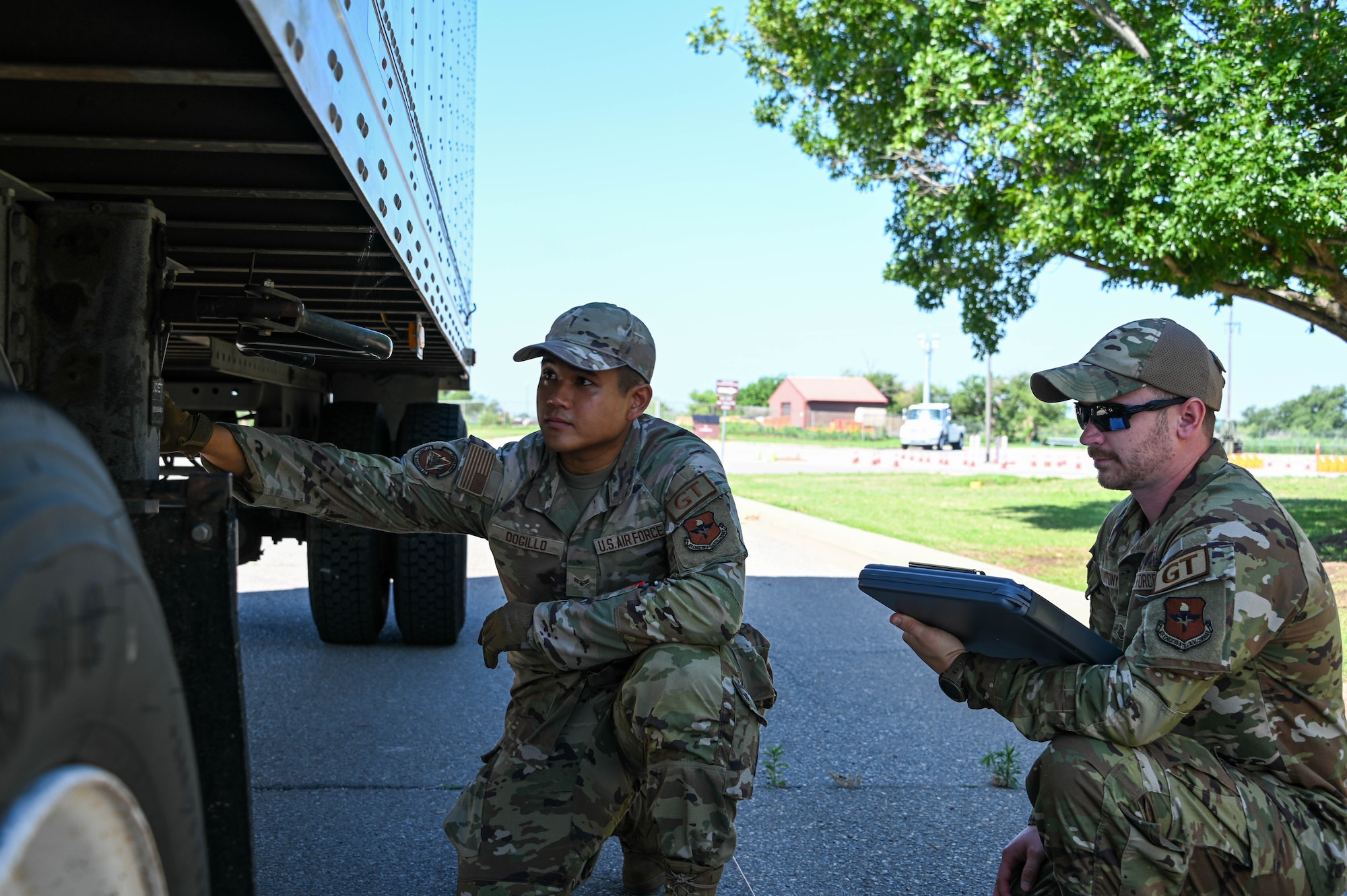 U.S. Air Force Staff Sgt. Benjamin Mantonya, 97th Logistics Readiness Squadron (LRS) training, validation, and operations examiner, watches as Airman 1st Class Rolfo Dogillo, 97th LRS ground transportation operator, checks over a vehicle at Altus Air Force Base, Oklahoma, May 30, 2023. Mantonya decided to reenlist in the Air Force for a second term after getting out. (U.S. Air Force photo by Senior Airman Kayla Christenson)