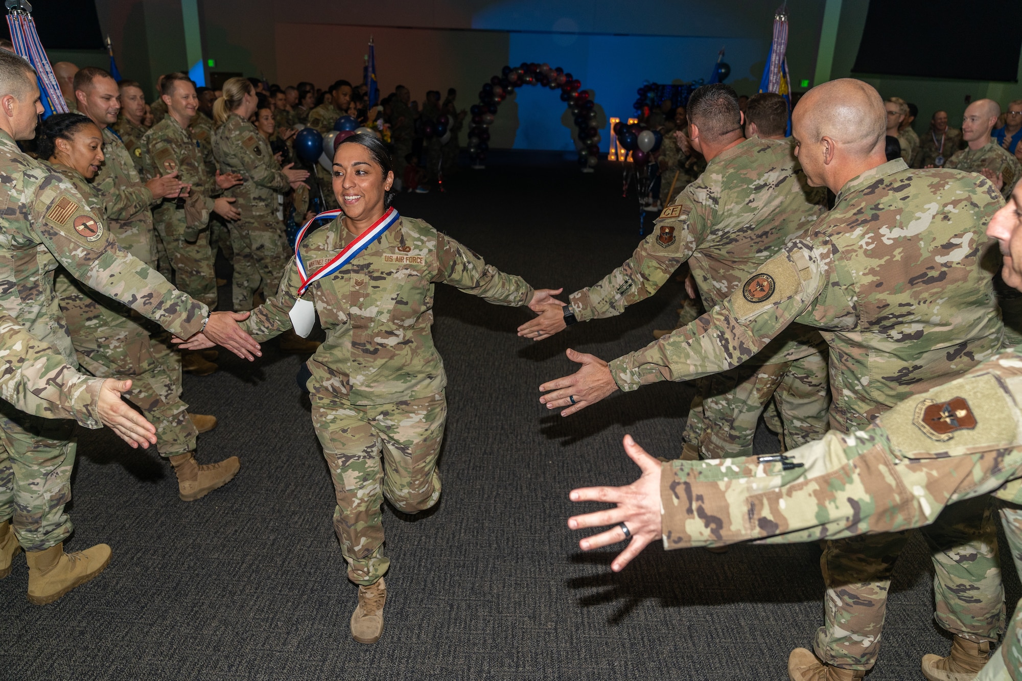 U.S. Air Force Tech. Sgt. Jessica Martinez Santana, 81st Security Forces Squadron flight sergeant, get high fives from her peers during the Master Sergeant Release party at Keesler Air Force Base, Mississippi, June 7, 2023.
