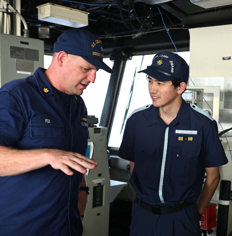 Lt. Cmdr. Ryan Fox, U.S. Coast Guard Cutter Stratton’s (WMSL 752) operation’s officer, speaks with a Japan Coast Guard servicemember sailing aboard the Stratton as the U.S., Japan and Philippine Coast Guards conduct combined operations in the South China Sea, June 5, 2023. Stratton’s crew are participating in the first trilateral engagements between the sea services while deployed to the Western Pacific to operate with regional allies and partner nations, reinforcing a rules-based order and maritime governance to promote a free and open Indo-Pacific. (U.S. Coast Guard photo by Chief Petty Officer Matt Masaschi)