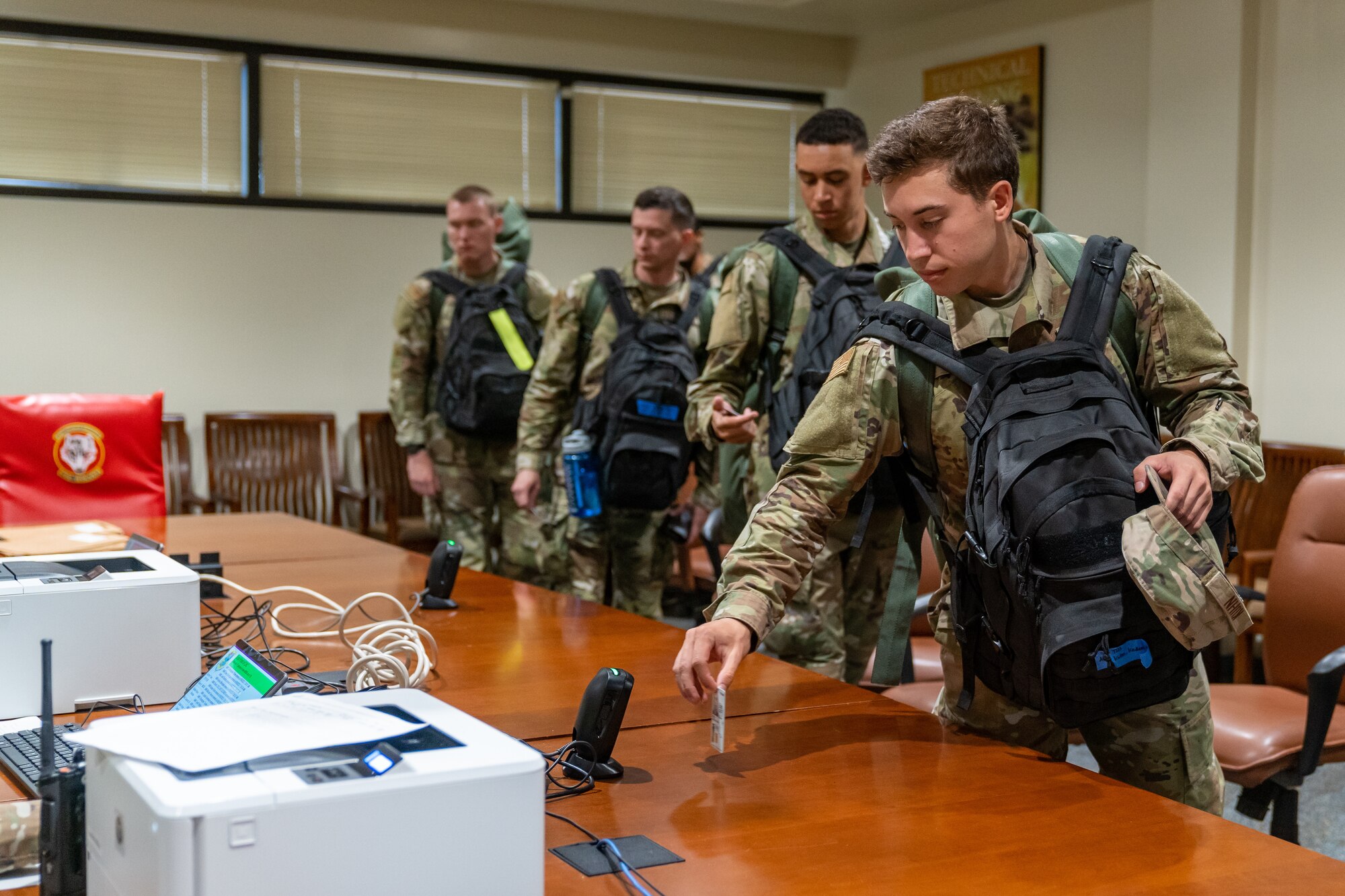 Students with the 336th Training Squadron scan their IDs in the out processing center at the Thompson Hall shelter during a hurricane exercise at Keesler Air Force Base, Mississippi, June 9, 2023.