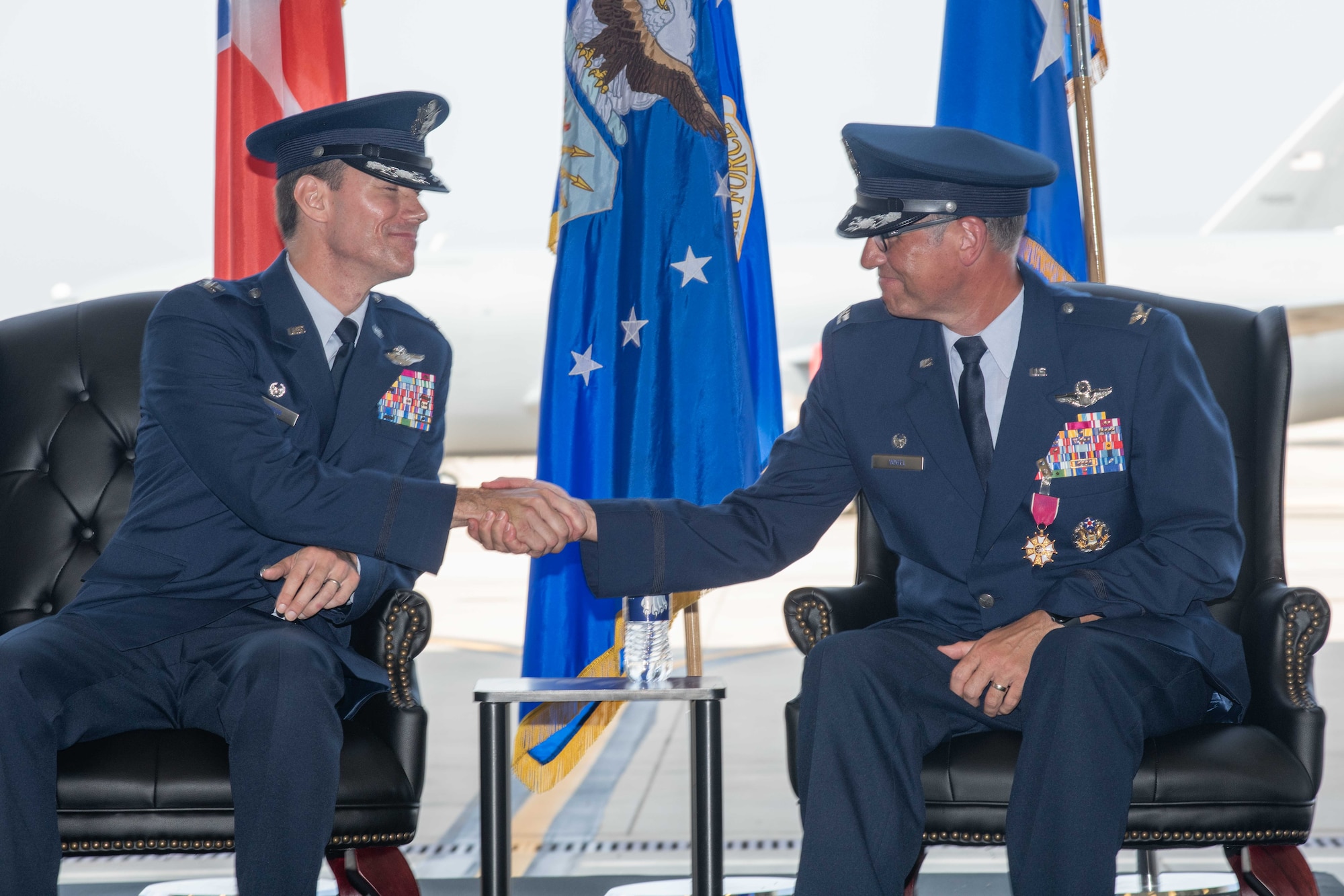 Colonel Cory M. Damon, 22nd Air Refueling Wing commander, shakes hands with Col. George N. Vogel, former 22nd ARW commander, at a change of command ceremony June 9, 2023, at McConnell Air Force Base, Kansas. During the ceremony, Vogel relinquished command of the Wing to Damon in front of an audience of service members, family, friends and community leaders. (U.S. Air Force photo by Staff Sgt. Adam Goodly)