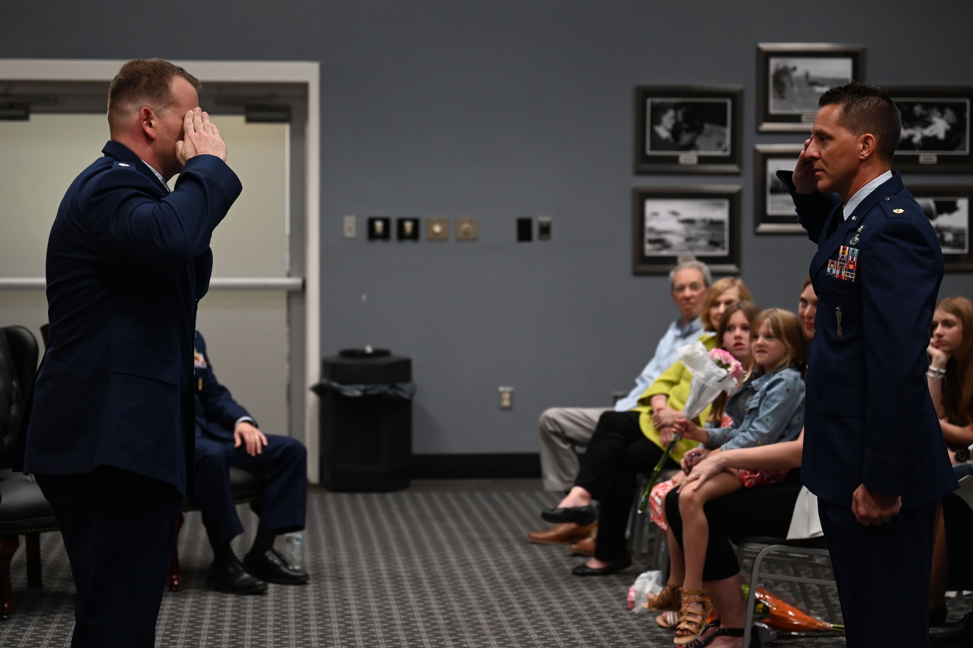 A Member of the 313th Training Squadron salutes U.S. Air Force Lt. Col. Garrett Williams, incoming 313th Training Squadron commander, during the change of command ceremony at the Powell Event Center, Goodfellow Air Force Base, Texas, June 9, 2023. The salute represents the squadron welcoming its new commander. (U.S. Air Force photo by Airman 1st Class Madison Collier)