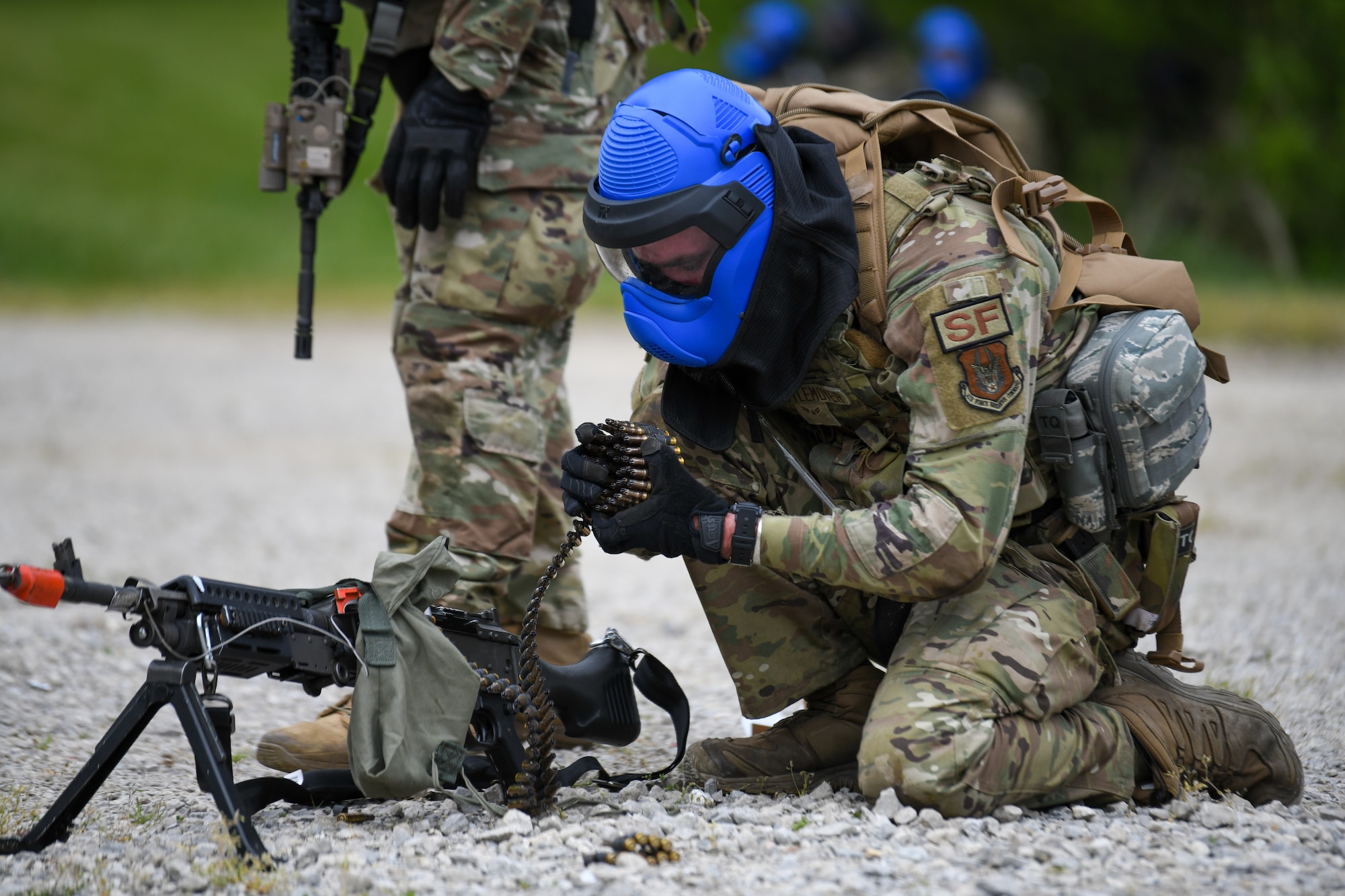 Airman Kevin Zettlemoyer, a member of the 914th Security Forces Squadron, Niagara Falls Air Reserve Station, New York, reloads his M249 light machine gun with blank rounds during an area security operations exercise at the Integrated Defense Leadership Course at Camp James A. Garfield Joint Military Training Center, Ohio, May 19, 2023.