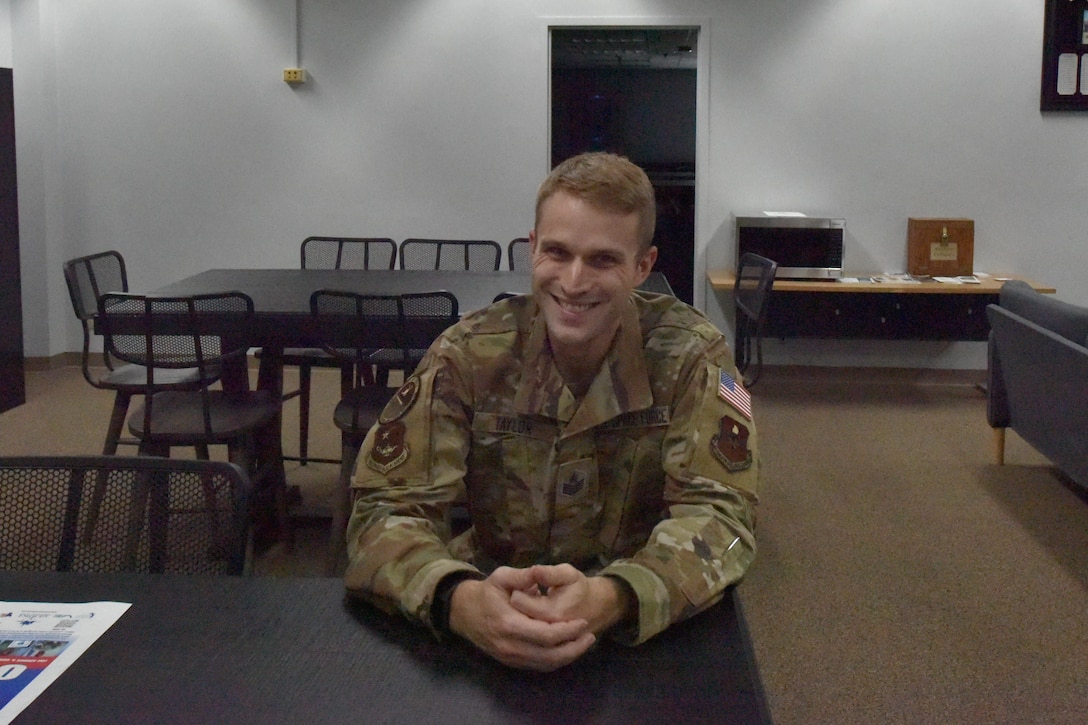 Space Force TSgt Samuel Taylor sits at a table at the Sheppard NCO Academy.