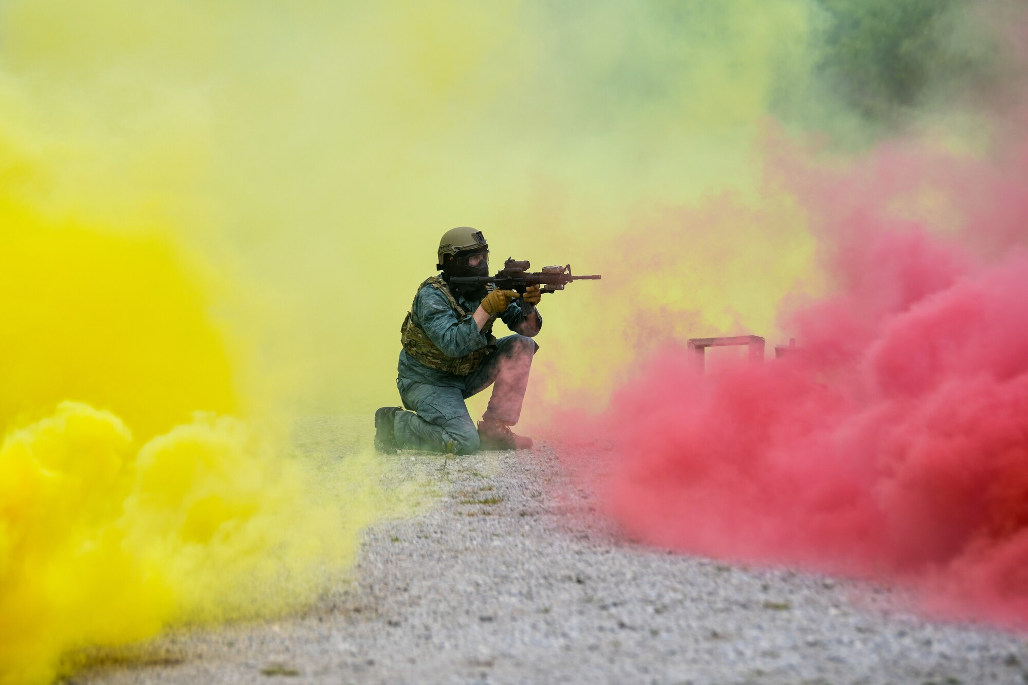 Master Sgt. Keith Carter, a member of the 433rd Security Forces Squadron, Lackland Air Force Base, Texas, engages an attacking force with dye-marker rounds from the cover of a smoke screen during an area security operations exercise, May 19, 2023, at Camp James A. Garfield Joint Military Training Center, Ohio.