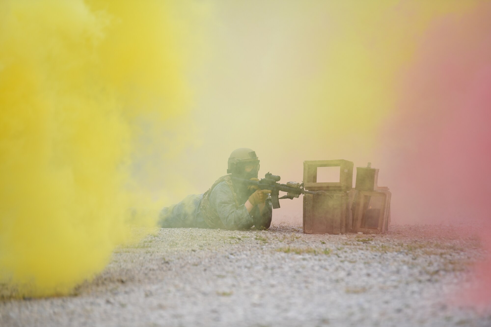 Master Sgt. Keith Carter, a member of the 433rd Security Forces Squadron, Lackland Air Force Base, Texas, engages an attacking force with dye-marker rounds from the over of a smoke screen during an area security operations exercise, May 19, 2023, at Camp James A. Garfield Joint Military Training Center, Ohio.