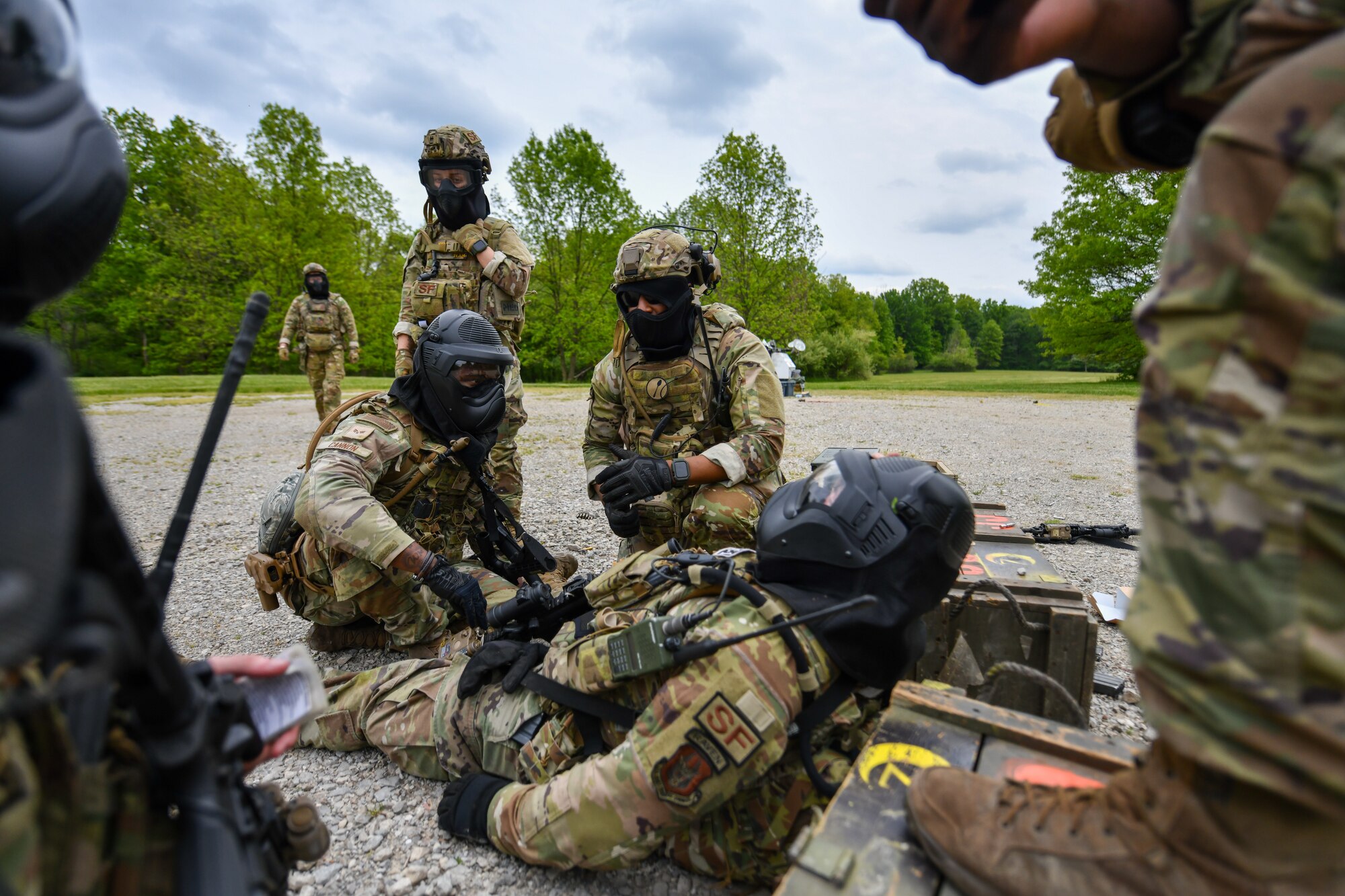 Members of the 914th Security Forces Squadron, Niagara Falls Air Reserve Station, New York, treat the simulated wounds of a fellow Defender during an area security operations exercise at the Integrated Defense Leadership Course at Camp James A. Garfield Joint Military Training Center, Ohio, May 19, 2023.