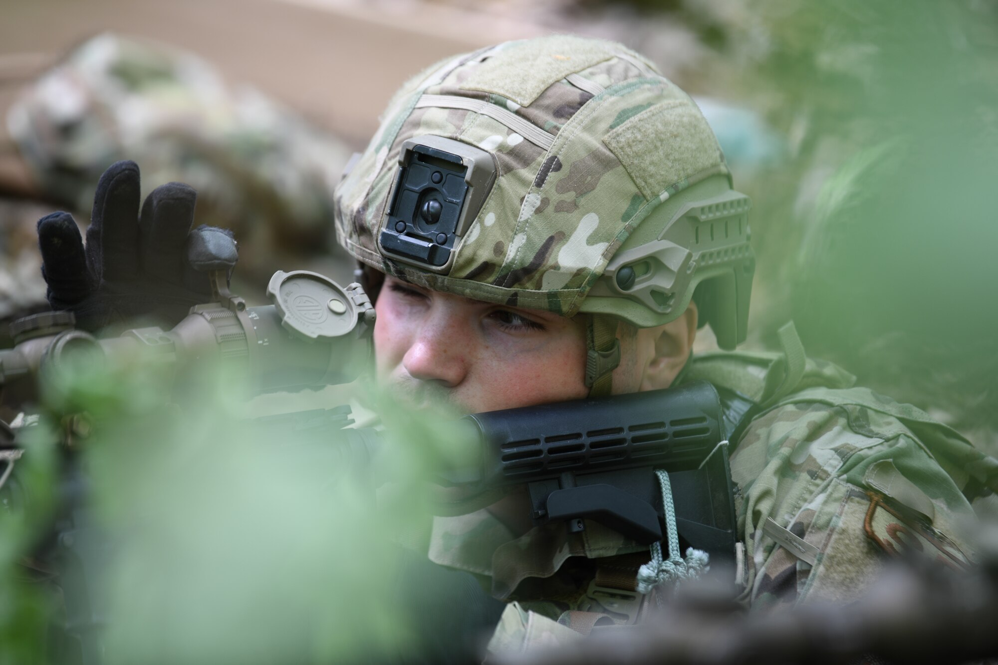Airman 1st Class Keven Zielenski, a member of the 439th Security Forces Squadron, Westover Air Reserve Base, Massachusetts, hones his rifle sight during a static defense exercise at the Integrated Defense Leadership Course at Camp James A. Garfield Joint Military Training Center, Ohio, May 19, 2023.