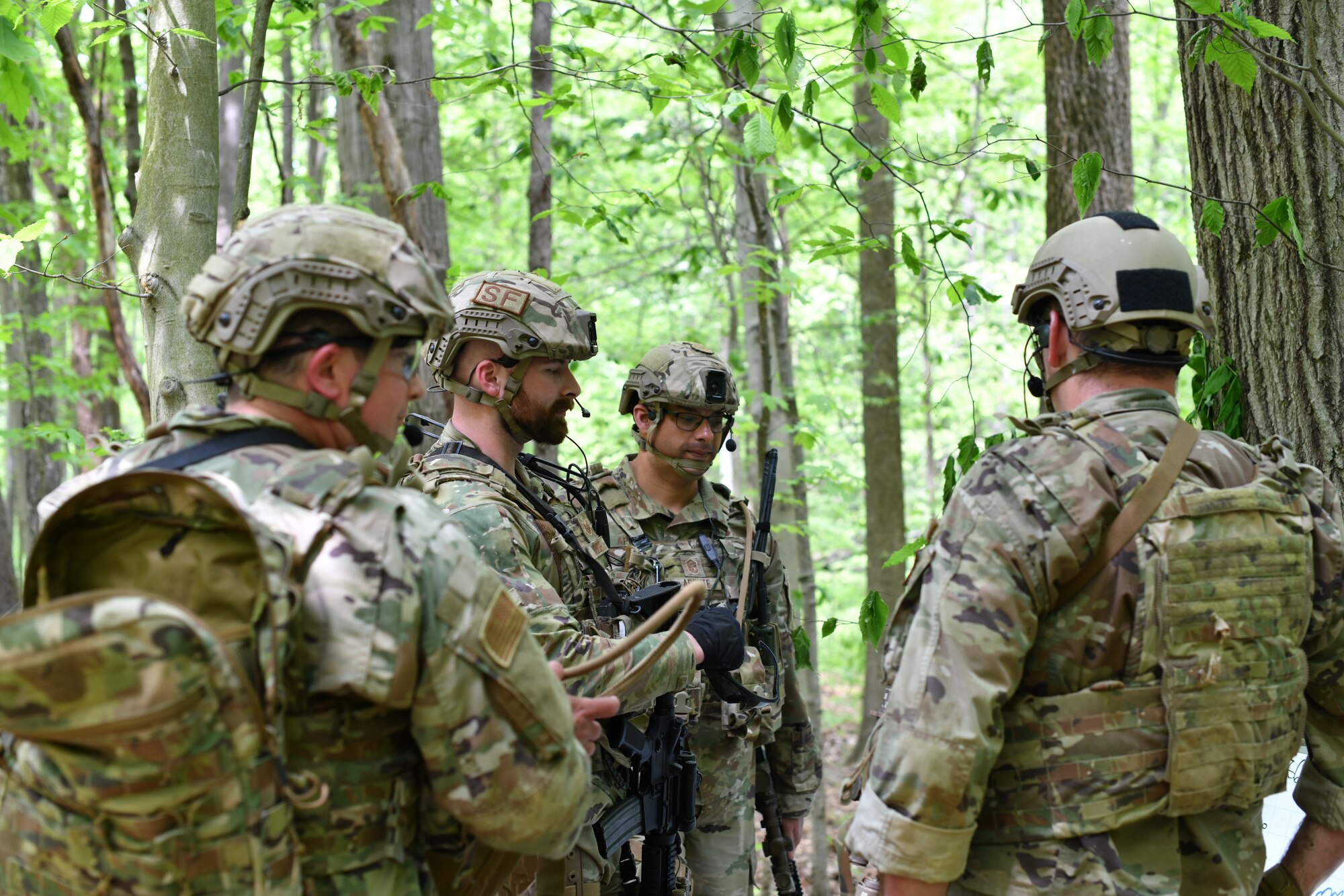 Members of the 439th Security Forces Squadron, Westover Air Reserve Base, Massachusetts, and the 914th Security Forces Squadron, Niagara Falls Air Reserve Station, New York, discuss tactics using a sector sketch during a static defense exercise, May 19, 2023, at Camp James A. Garfield Joint Military Training Center, Ohio.