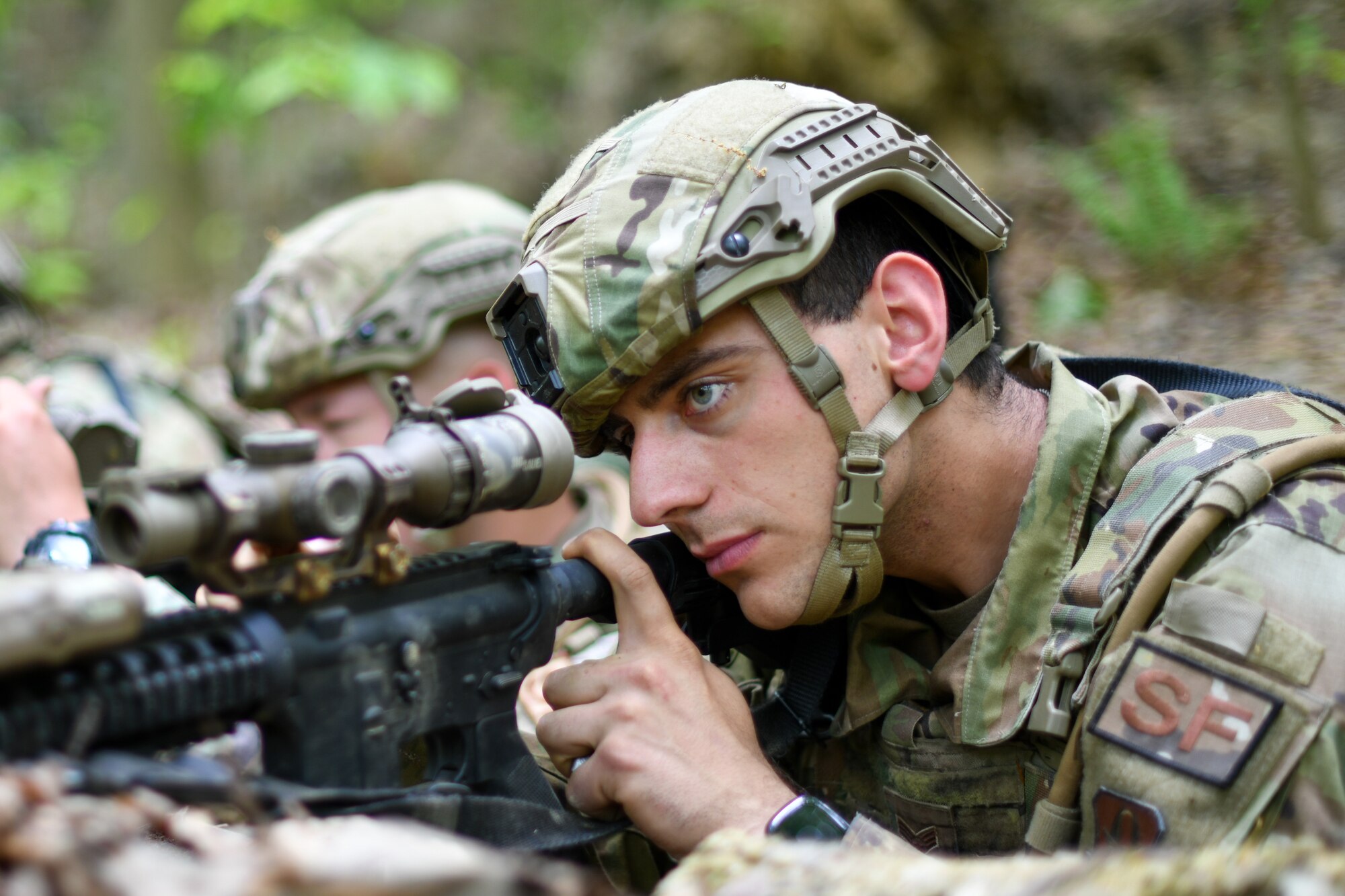 Airman First Class Francesco Kleinlercher, a member of the 439th Security Forces Squadron, Westover Air Reserve Base, Massachusetts, scans his surroundings using his M4 carbine’s scope during a static defense exercise, May 19, 2023, at Camp James A. Garfield Joint Military Training Center, Ohio.
