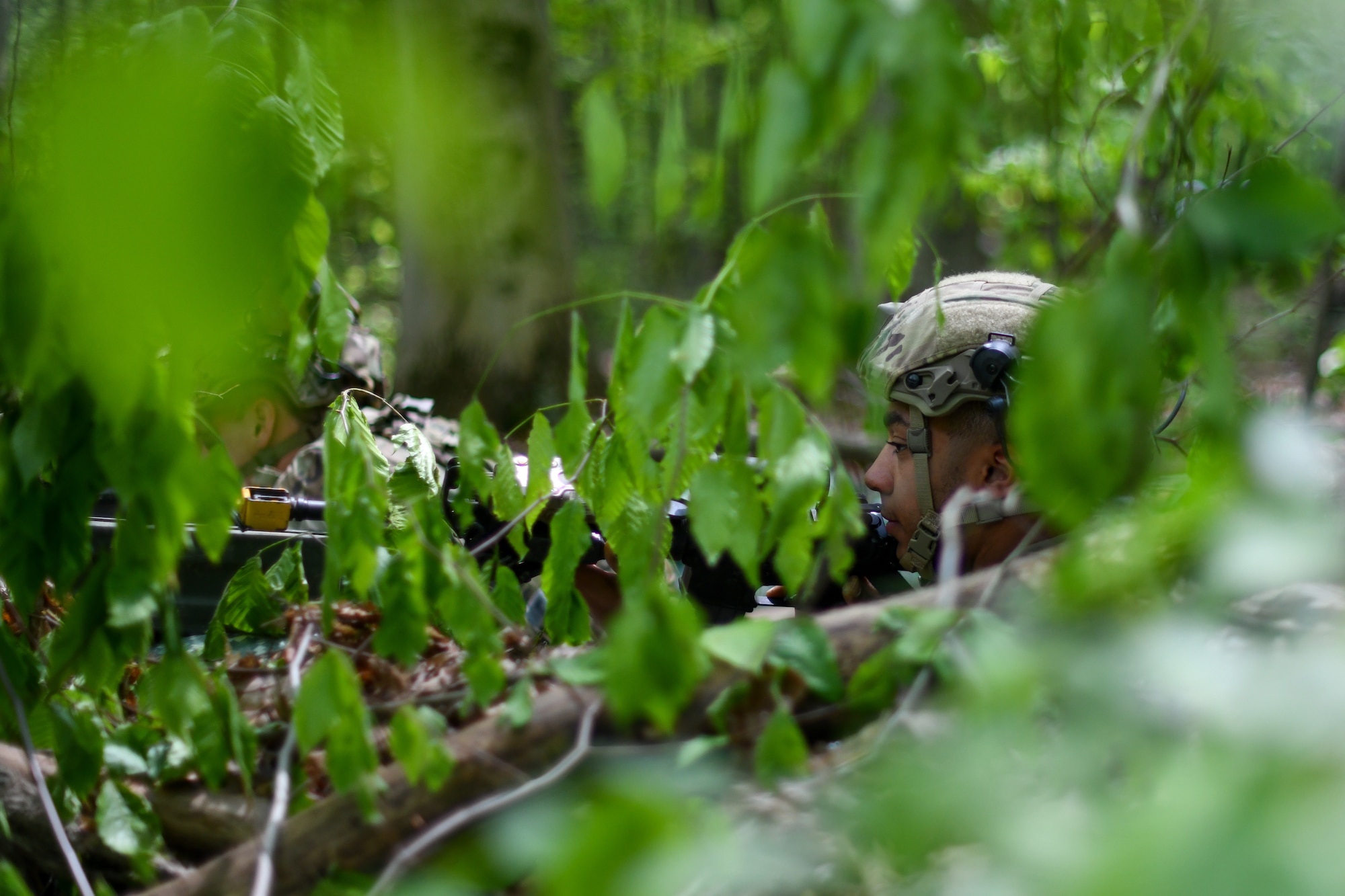 Airman First Class Malachi Hayward, a member of the 439th Security Forces Squadron, Westover Air Reserve Base, Massachusetts, keeps a watchful eye for movement during a static defense exercise, May 19, 2023, at Camp James A. Garfield Joint Military Training Center, Ohio.