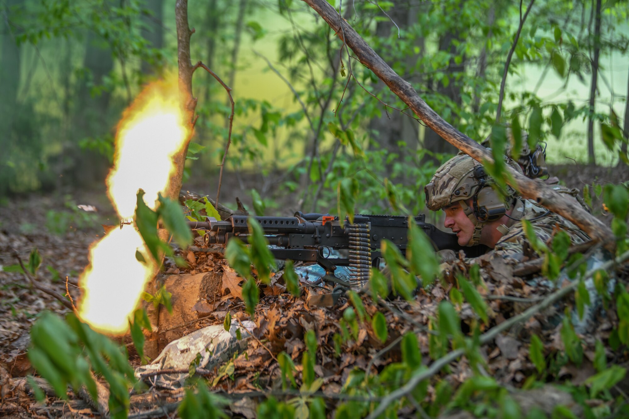 Senior Airman Dylan Milbrand, a member of the 914th Security Forces Squadron, Niagara Falls Air Reserve Station, New York, fires blank rounds from his M240 machine gun during a static defense exercise, May 19, 2023, at Camp James A. Garfield Joint Military Training Center, Ohio.