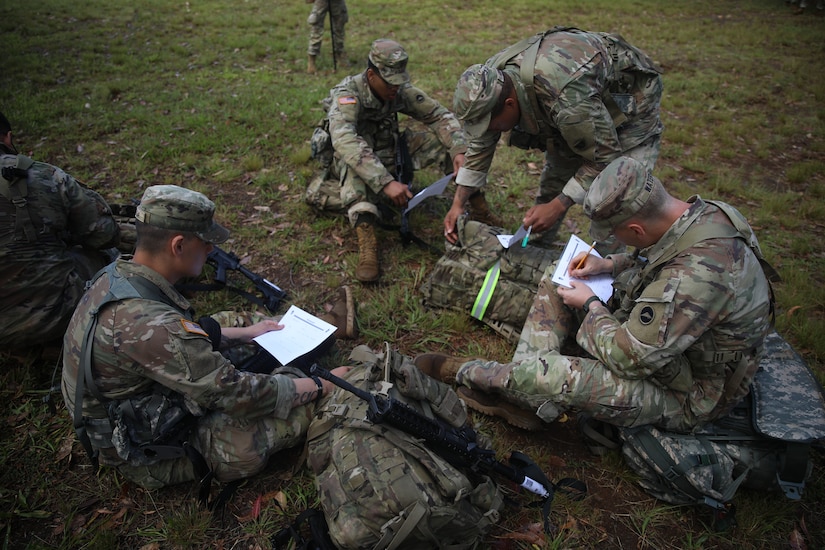 U.S. Army Pacific Soldiers fill out basic information for their E3B scorecards during the Best Warrior Competition on Schofield Barracks, Hawaii, June 6th, 2023.