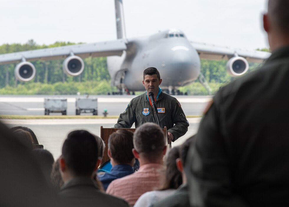 Lt. Col. Phillip Summers, 9th Airlift Squadron commander, gives remarks during the 9th AS change of command ceremony at Dover Air Force Base, Delaware, June 9, 2023. The 9th AS routinely trains to provide global reach with unique outsized and oversized airlift capability on the C-5M Super Galaxy. (U.S. Air Force photo by Roland Balik)