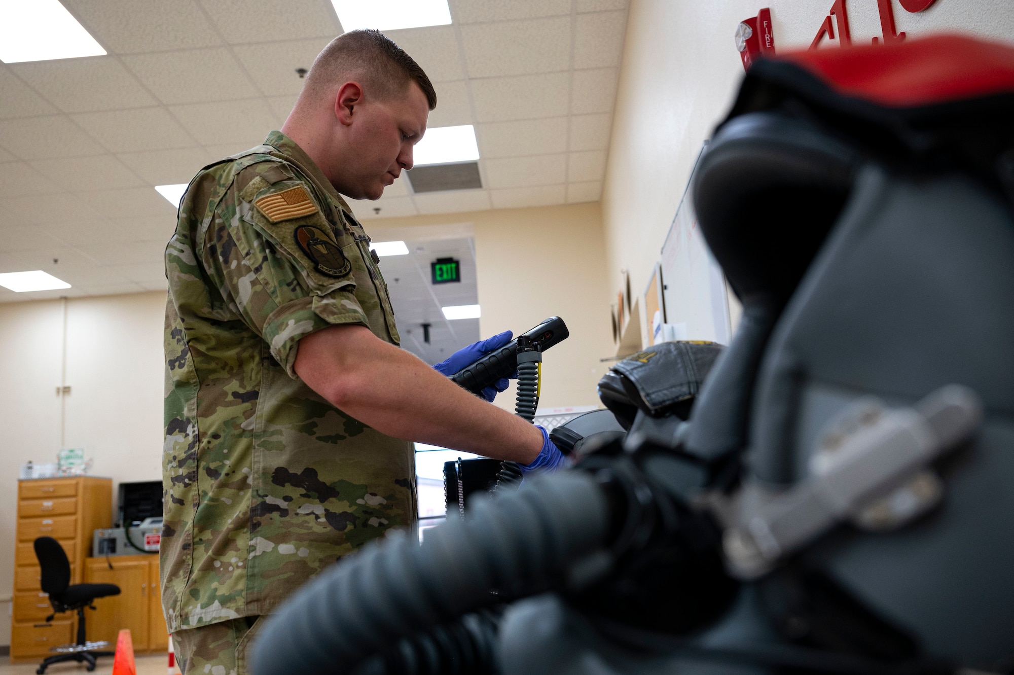 U.S. Air Force Senior Airman Kenneth Ball, 54th Operations Support Squadron aircrew flight equipment journeyman, tests the sound quality of helmets at Holloman Air Force Base, New Mexico, June 8, 2023. The 54th OSS AFE is responsible for providing quality maintenance on the flight gear of every pilot on Holloman ensuring their safety during flights. (U.S. Air Force photo by Airman 1st Class Isaiah Pedrazzini)