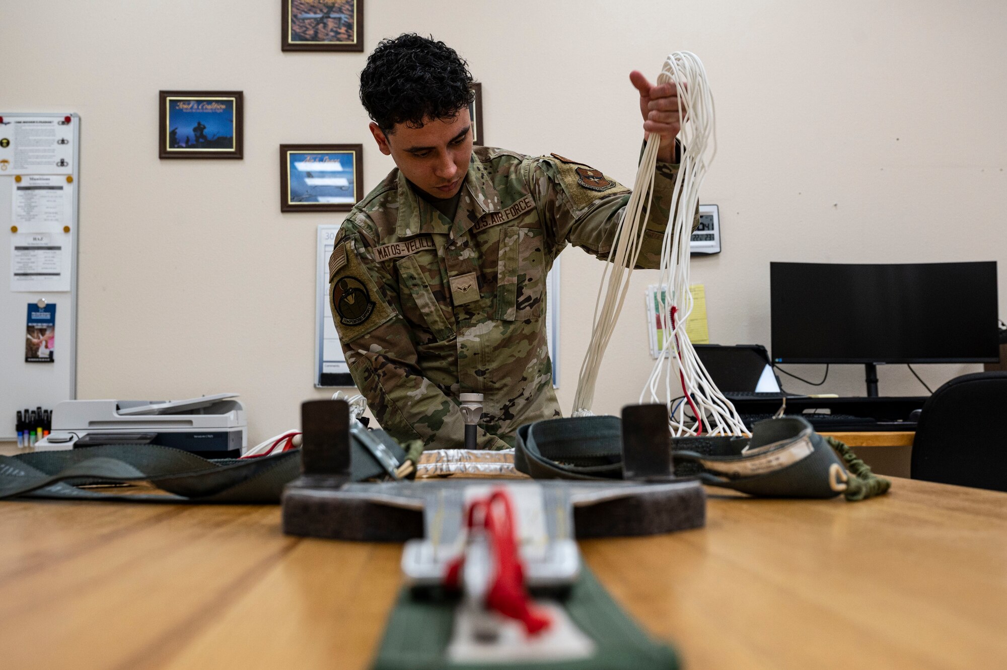 U.S. Air Force Airman Juan Matos-Velilla, 54th Operations Support Squadron aircrew flight equipment apprentice, unpacks a parachute at Holloman Air Force Base, New Mexico, June 8, 2023. The 54th OSS AFE ensures that Holloman’s pilots receive the best flight equipment that will guarantee their safety in the skies. (U.S. Air Force photo by Airman 1st Class Isaiah Pedrazzini)