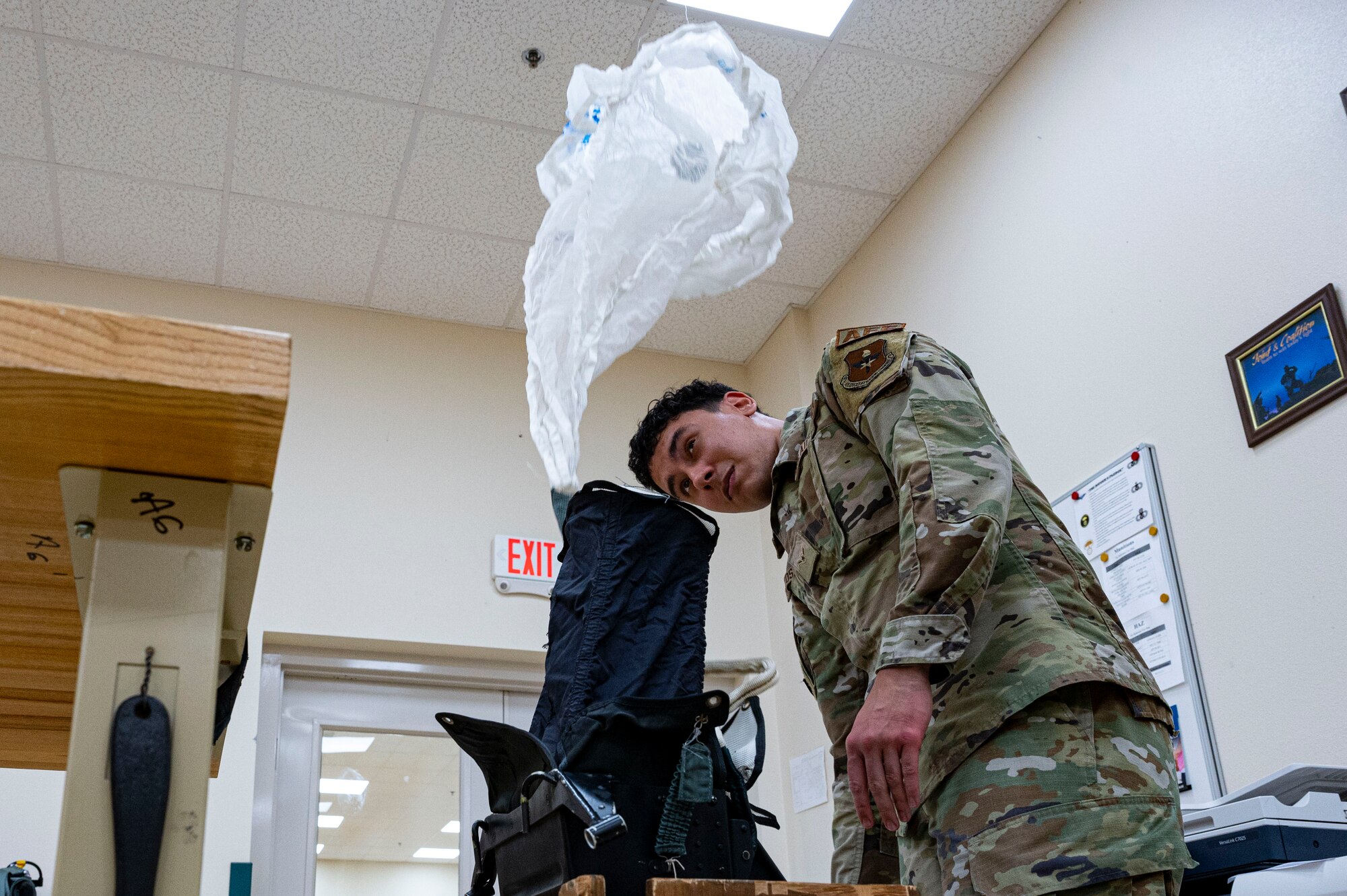 U.S. Air Force Airman Juan Matos-Velilla, 54th Operations Support Squadron aircrew flight equipment apprentice, tests the capability of a parachute at Holloman Air Force Base, New Mexico, June 8, 2023. The 54th OSS AFE ensures that Holloman’s pilots receive the best flight equipment that will guarantee their safety in flight. (U.S. Air Force photo by Airman 1st Class Isaiah Pedrazzini)