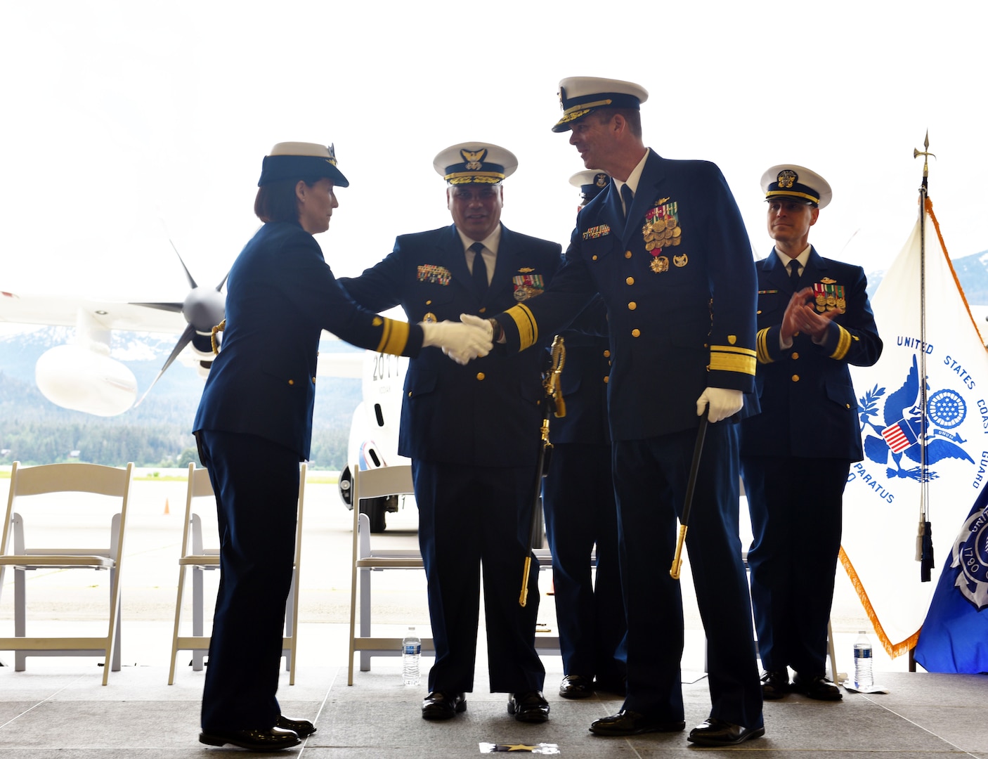 Rear Admiral Megan Dean, Seventeenth district commander, speaks during the Coast Guard 17th District change-of command ceremony at the Alaska Army National Guard Army Aviation Operating Facility in Juneau, Alaska, June 8, 2023.
 
Rear Adm. Nathan Moore transferred the command of the Coast Guard’s 17th District to Rear Adm. Megan Dean under the supervision of Vice Adm. Andrew J. Tiongson.
 
As the 17th District commander, Dean, will be responsible for all Coast Guard operations throughout Alaska, the North Pacific and the Arctic which includes protecting life and property, enforcing federal laws and treaties, preserving living marine resources, and promoting national security. Headquartered in Juneau, the 17th District encompasses 3.8 million square miles and over 44,000 miles of shoreline. During an average year the 2,500 active duty, reserve, civilian and auxiliary personnel of the 17th District save 264 lives and assist 636 people.
 
Dean was previously assigned as the Coast Guard director of governmental and public affairs. She was responsible for responsible for external engagement with Congress, the media, and other inter-governmental entities.
 
Moore, who originally took command of the 17th District in April 2021, is transferring to Portsmouth, VA., where he will serve as the deputy commander for Coast Guard Atlantic Area.
  
A change-of-command ceremony marks a transfer of total responsibility and authority from one individual to another. It is a time-honored tradition conducted before the assembled crew, as well as honored guests and dignitaries to formally demonstrate the continuity of the authority within a command