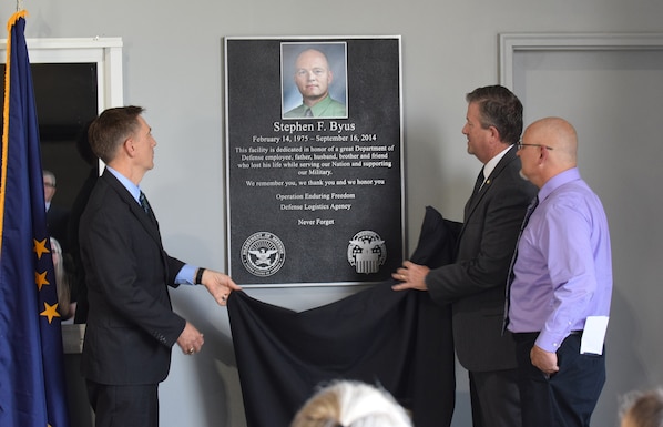 The Army Expeditionary Civilian Workforce alongside Defense Logistics Agency senior leaders and the family of Stephen Byus officially opened the Stephen Byus Central Issue Facility Warehouse June 8 during a memorialization ceremony at Camp Atterbury, Indiana.