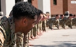 Special tactics operators conduct push ups to honor the fallen