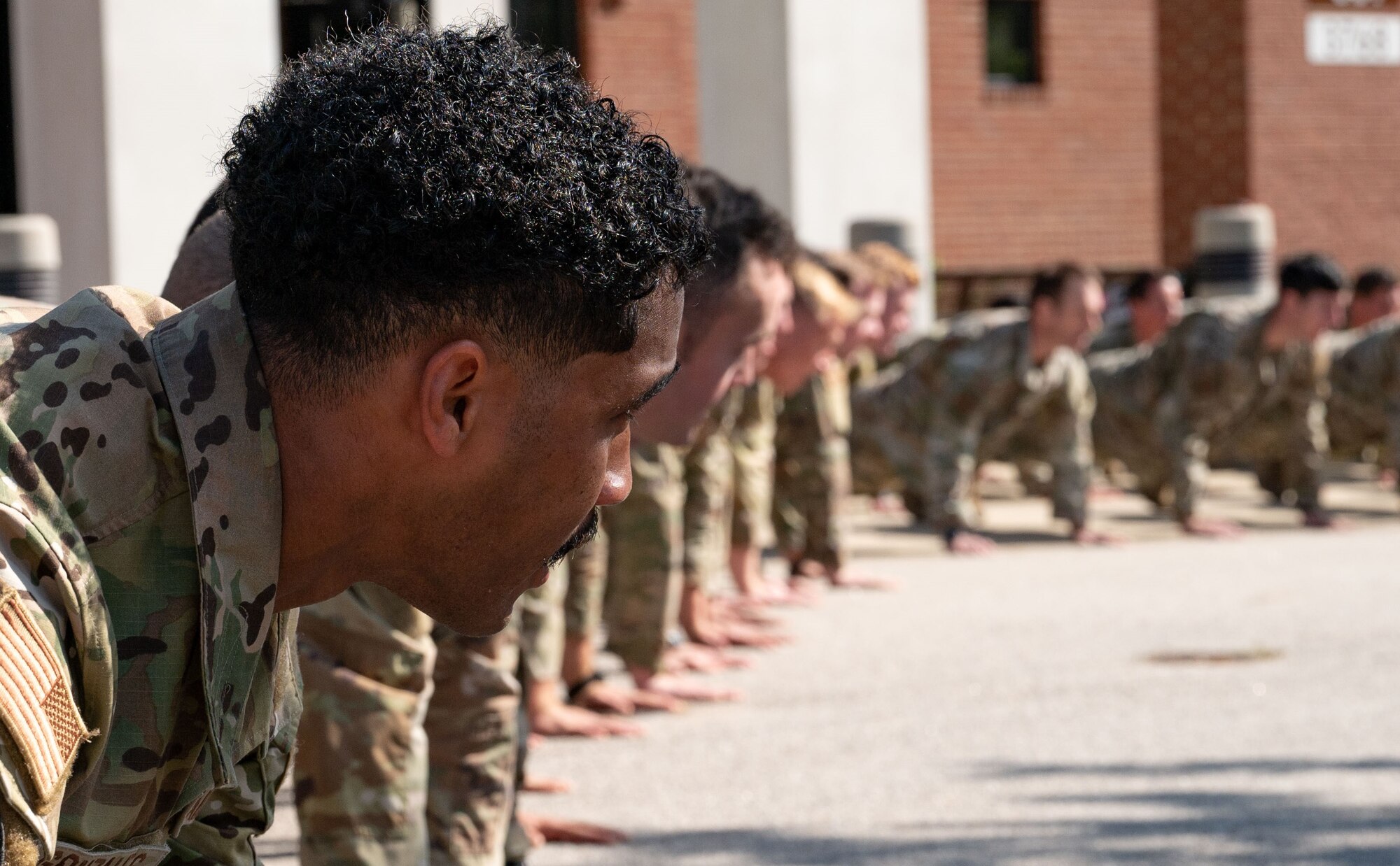 Special tactics operators conduct push ups to honor the fallen