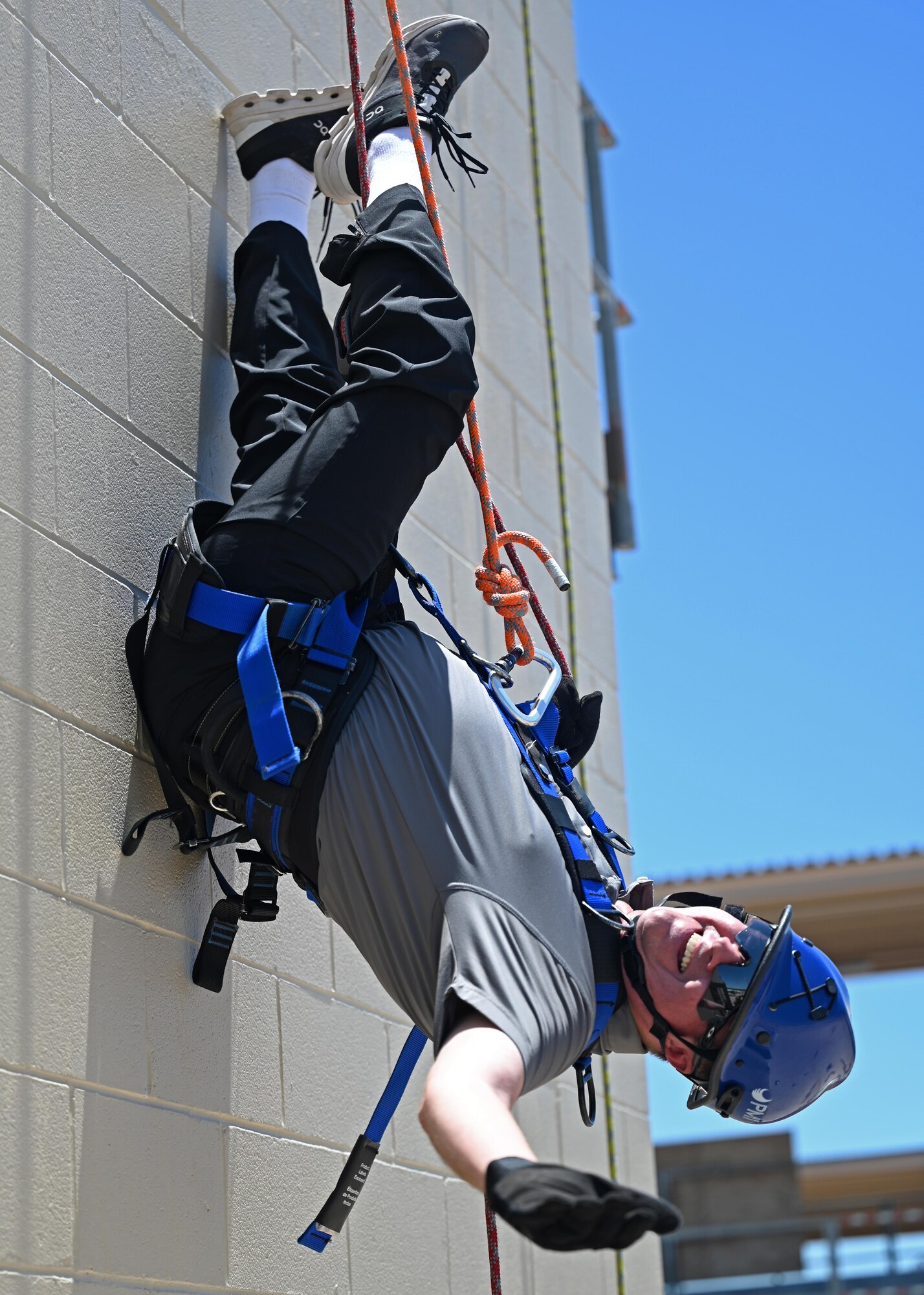 A 17th Training Wing honorary commander, Scott Creesy, inverts at the Louis F. Garland Department of Defense Fire Academy on Goodfellow Air Force Base, Texas, June 8, 2023. Repelling is a follow-on course that teaches students how to save people from steep cliffs, tall buildings, and waterways. (U.S. Air Force photo by Senior Airman Sarah Williams)