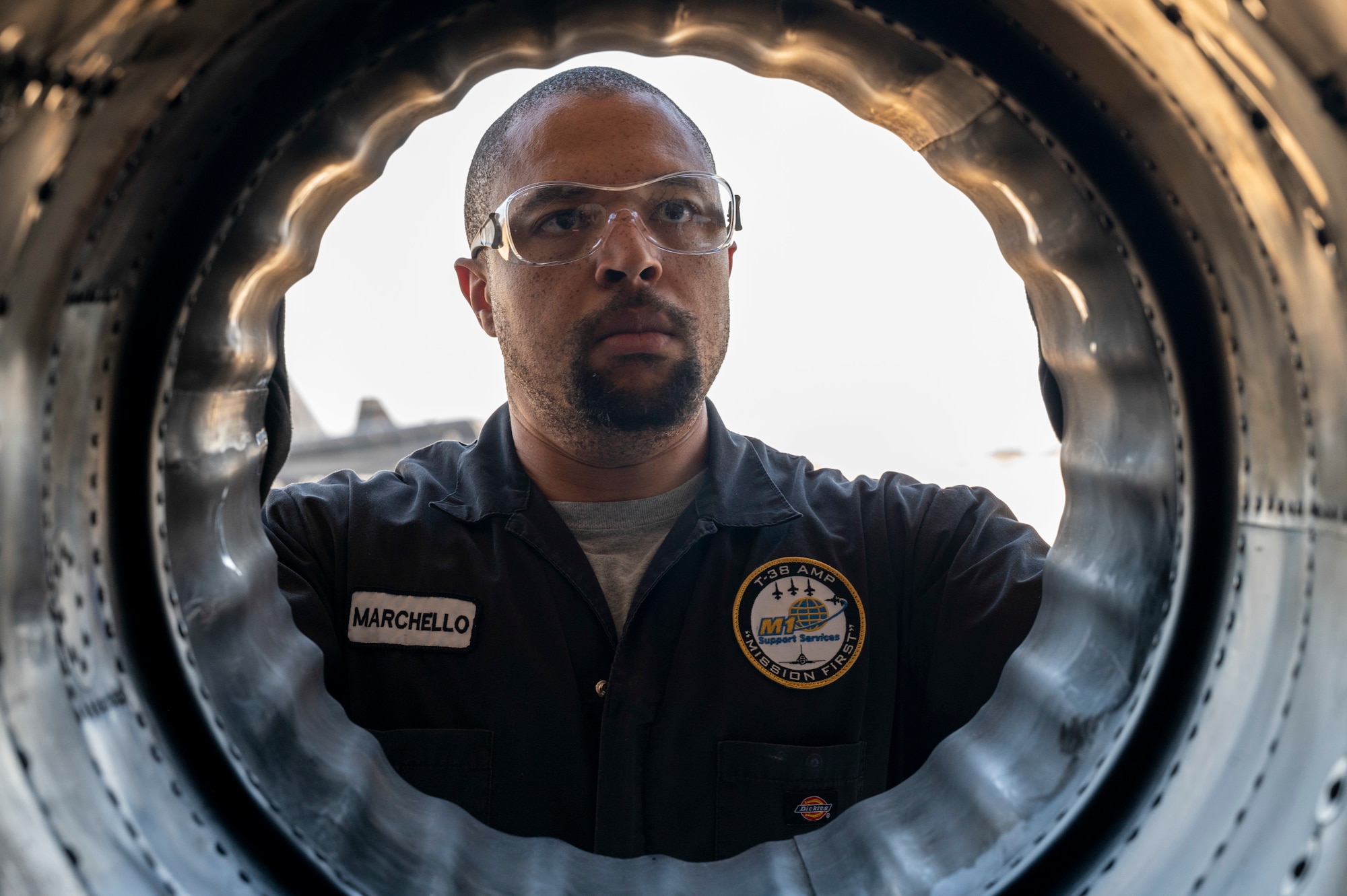 Marchello Carrington, T-38 Aircraft Maintenance Program aircraft general technician, assesses  for damage inside a T-38A/B engine panel at Holloman Air Force Base, New Mexico, June 8, 2023.