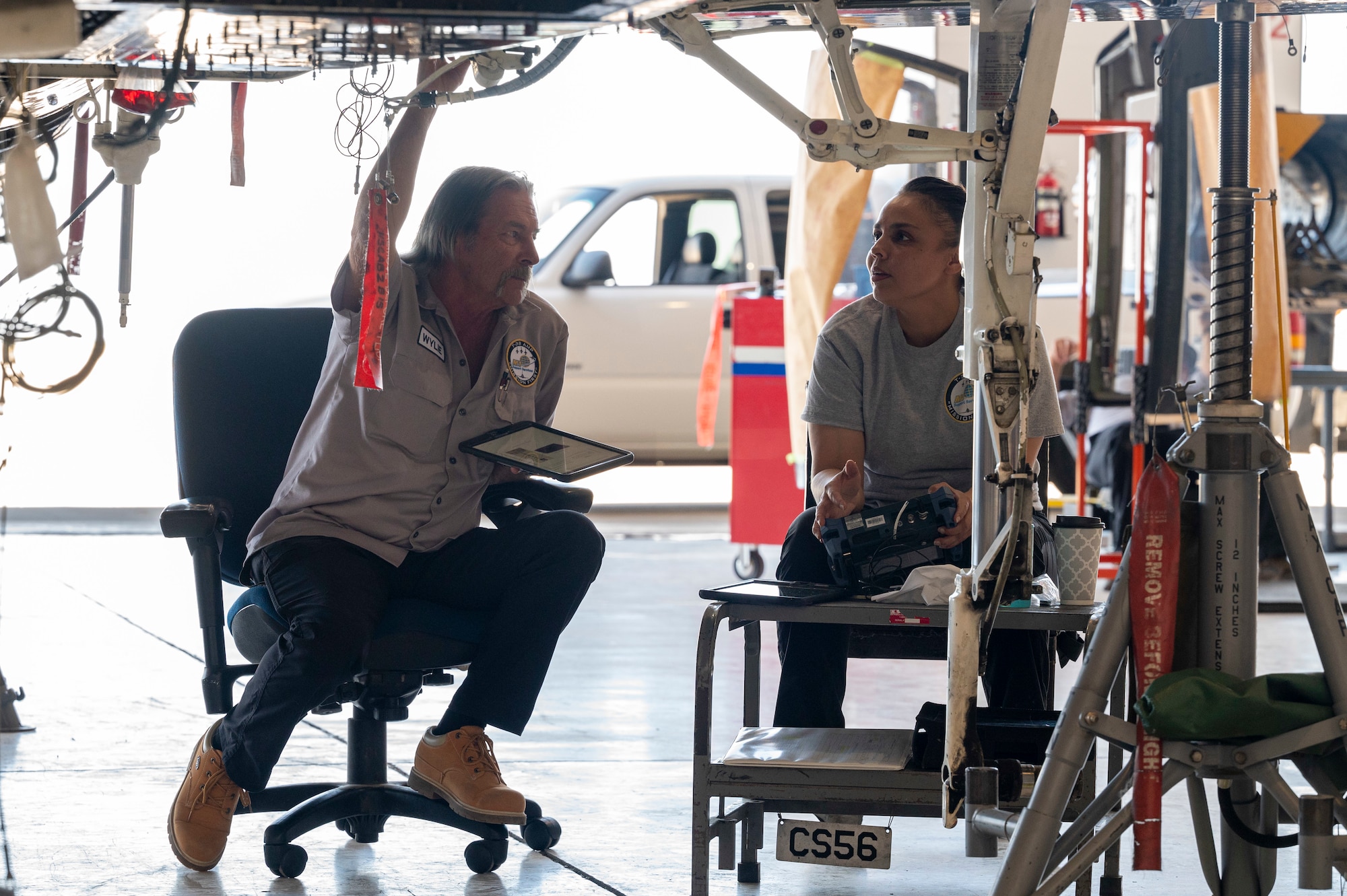 William Wylie, T-38 Aircraft Maintenance Program nondestructive inspection technician, left, and Alma Carrington, T-38 AMP NDI technician look over the technician orders for the T-38A/B Talon at Holloman Air Force Base, New Mexico, June 8, 2023.
