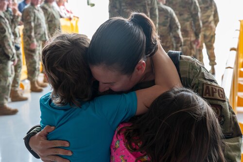 Tech Sgt. Stephanie Kreofsky, a 934th Aircraft Maintenance Squadron crew chief, hugs her children after arriving home from a deployment to Djibouti at Minneapolis-St. Paul Air Reserve Station, Minnesota, on June 8, 2023. Kreofsky and approximately 150 934th Airlift Wing Airmen returned from deployment after being gone for three months. (U.S. Air Force photo by Senior Airman Matthew Reisdorf)