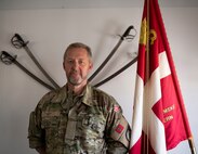 Capt. Jens Peter Koefoed, Danish Homeguard Bornholm, stands in front of a Danish Flag in Bornholm, Denmark, June 8, 2023.