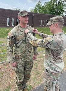 Staff Sgt. Alex Miller, assigned to the Virginia National Guard’s Lynchburg-based 1st Battalion, 116th Infantry Regiment, 116th Infantry Brigade Combat Team, receives his Expert Infantryman Badge. (Courtesy photo)