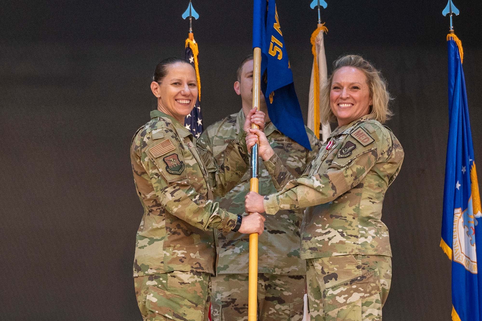 U.S. Air Force Col. Jennifer Vecchione, left, 51st Medical Group commander, receives the guidon from Lt. Col. Shannon Hunt, 51st Operational Medical Readiness Squadron outgoing commander, right, at Osan Air Base, Republic of Korea, June 8, 2023. In a change of command ceremony, the guidon symbolizes the transfer of command, the authority and responsibility associated with it. (U.S. Air Force photo by Airman 1st Class Aaron Edwards)