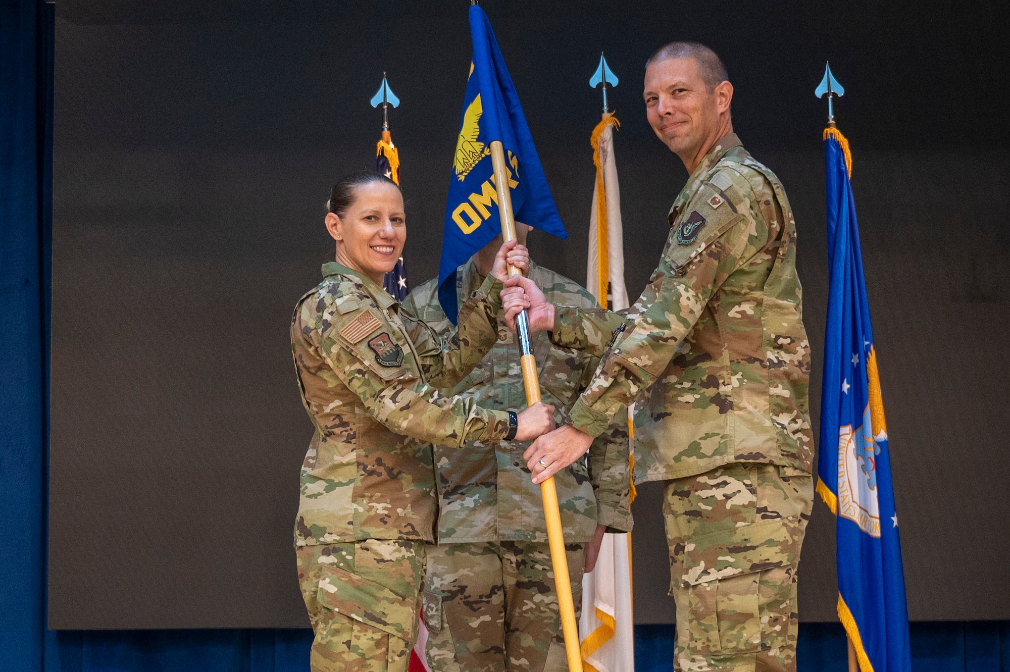U.S. Air Force Col. Jennifer Vecchione, left, 51st Medical Group commander, presents the guidon to Lt. Col. Jamie Cornett, 51st Operational Medical Readiness Squadron incoming commander, as a symbol of his taking command of the 51st OMRS at Osan Air Base, Republic of Korea, June 8, 2023. Prior to taking command, Cornett served as the 36th Healthcare Operations Squadron commander, Anderson Air Force Base, Guam. (U.S. Air Force photo by Airman 1st Class Aaron Edwards)