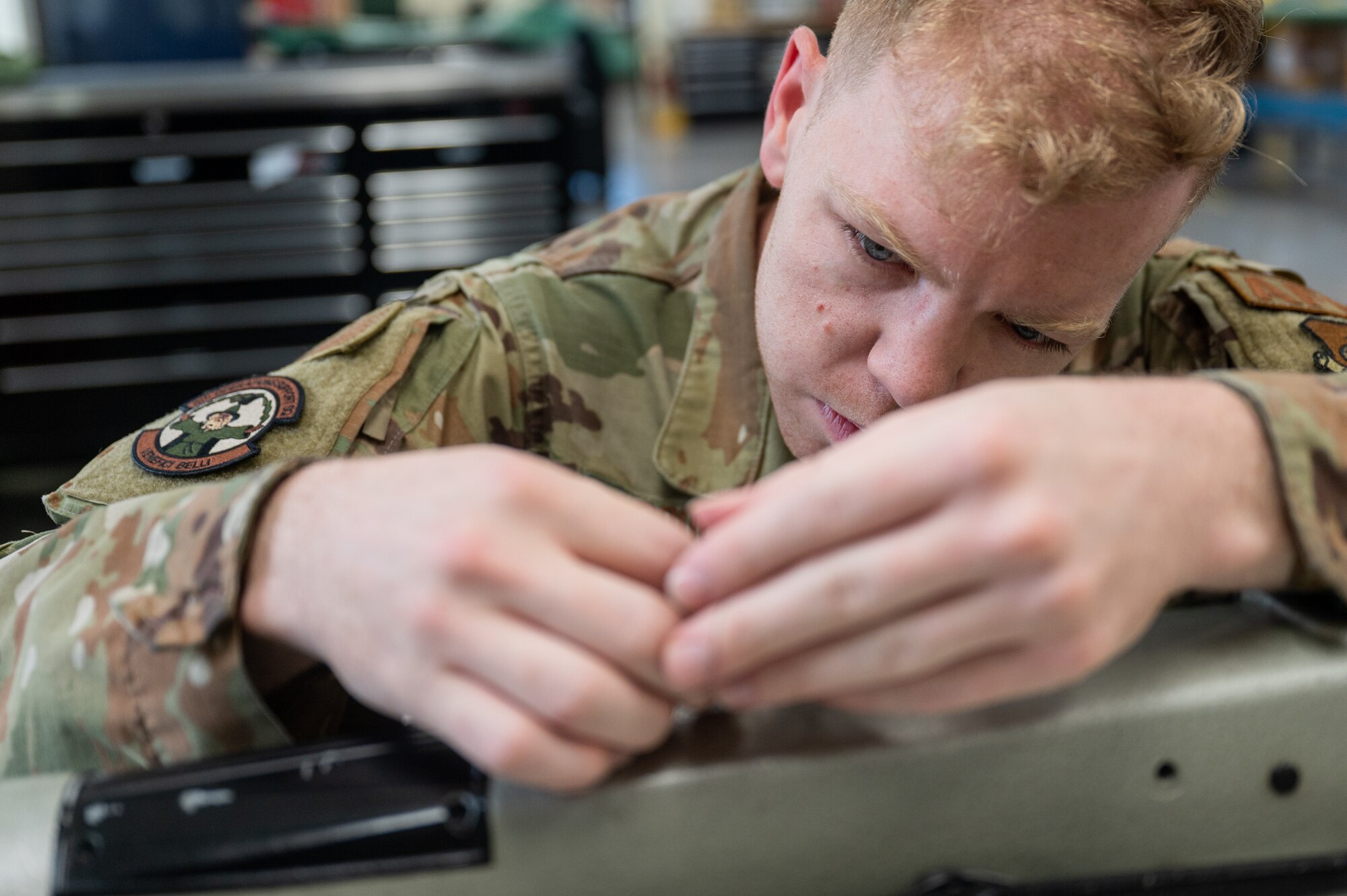 Staff Sgt. Nathan Gooch prepares a sewing machine for use at Kunsan Air Base
