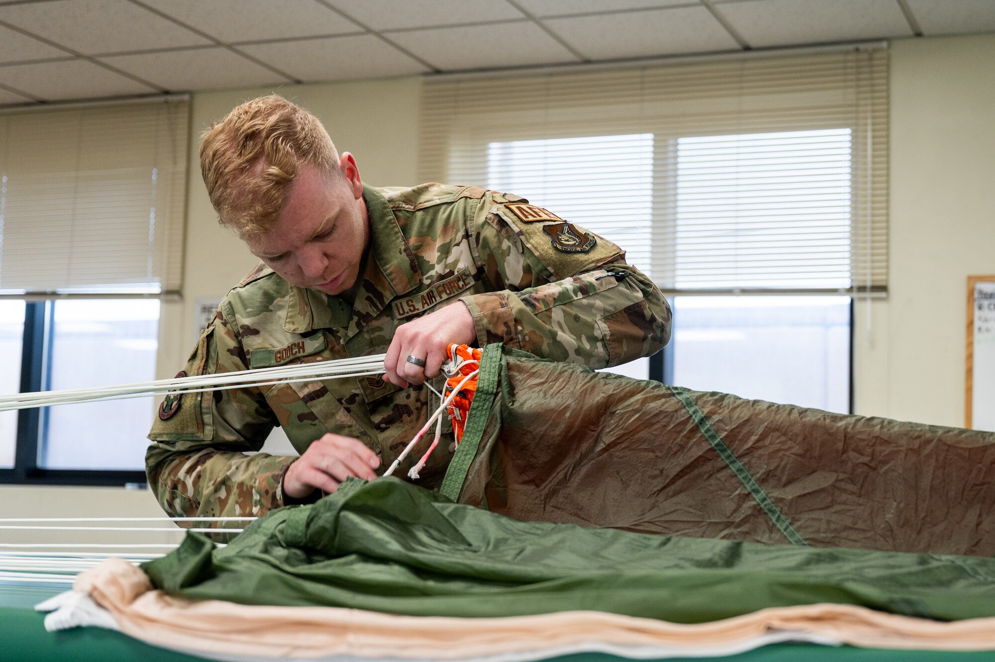 Gooch inspects parachute equipment at Kunsan Air Base