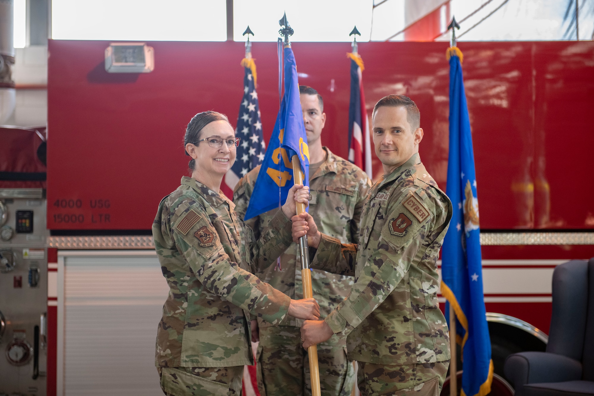 Maj. John Kust, 423d Communications Squadron incoming commander, right, accepts command of the 423d CS from Col. Valerie Long, 423d Air Base Group commander, at RAF Alconbury