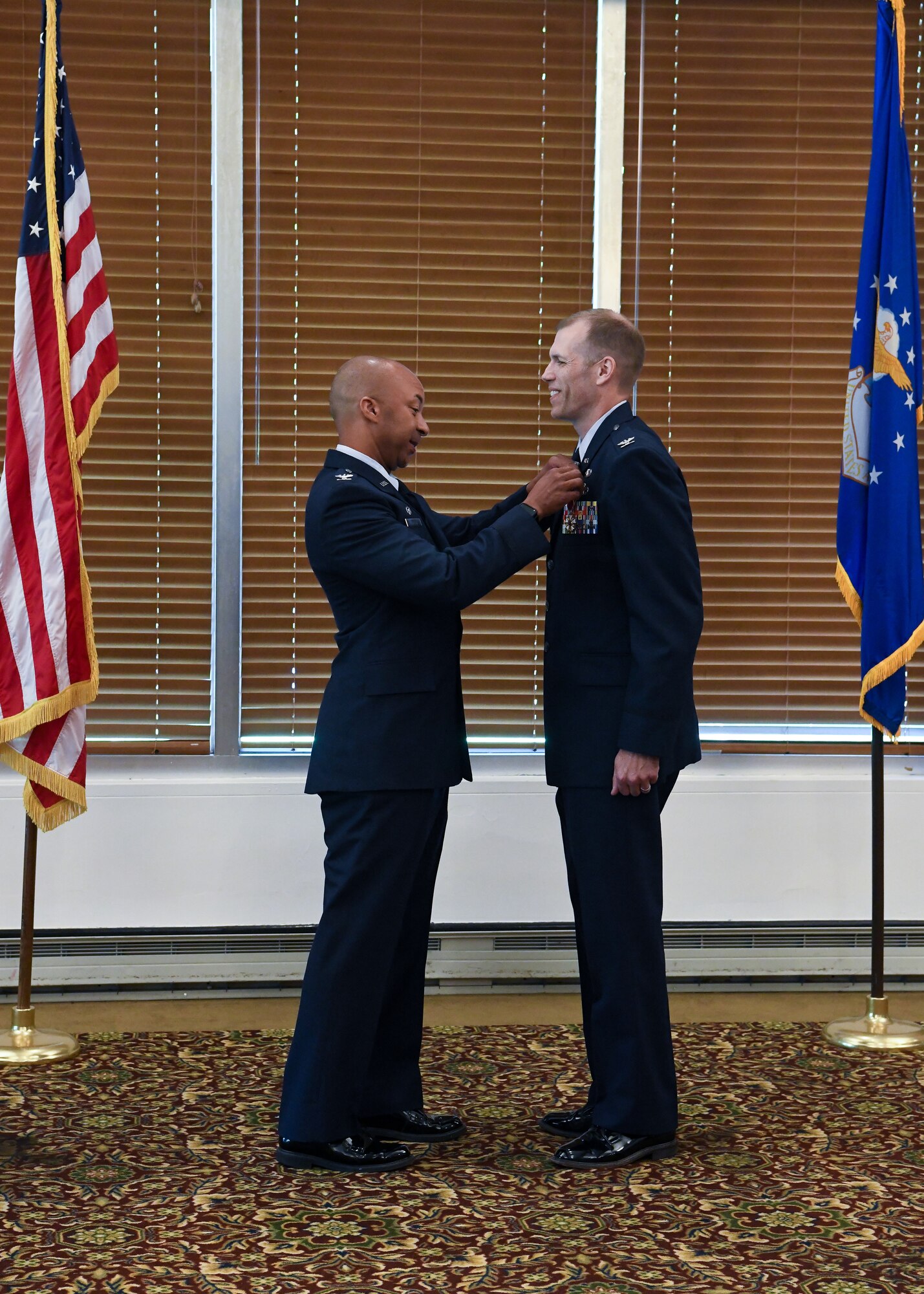 Air Force officer awarding medal to fellow officer