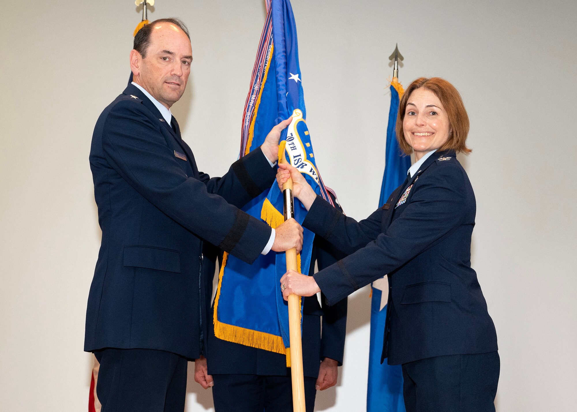 U.S. Air Force Lt. Gen. Kevin B. Kennedy, 16th Air Force (Air Forces Cyber) commander, gives the 70th Intelligence, Surveillance and Reconnaissance Wing guidon to U.S. Air Force Col. Celina E. Noyes, 70th ISRW commander, during a Change of Command Ceremony June 9, 2023, at Fort George G. Meade, Maryland. Kennedy was the presiding officer for the ceremony, which U.S. Air Force Col. Craig S. Miller relinquished command of the 70th ISRW to Noyes. (U.S. photo by Staff Sgt. Kevin Iinuma)