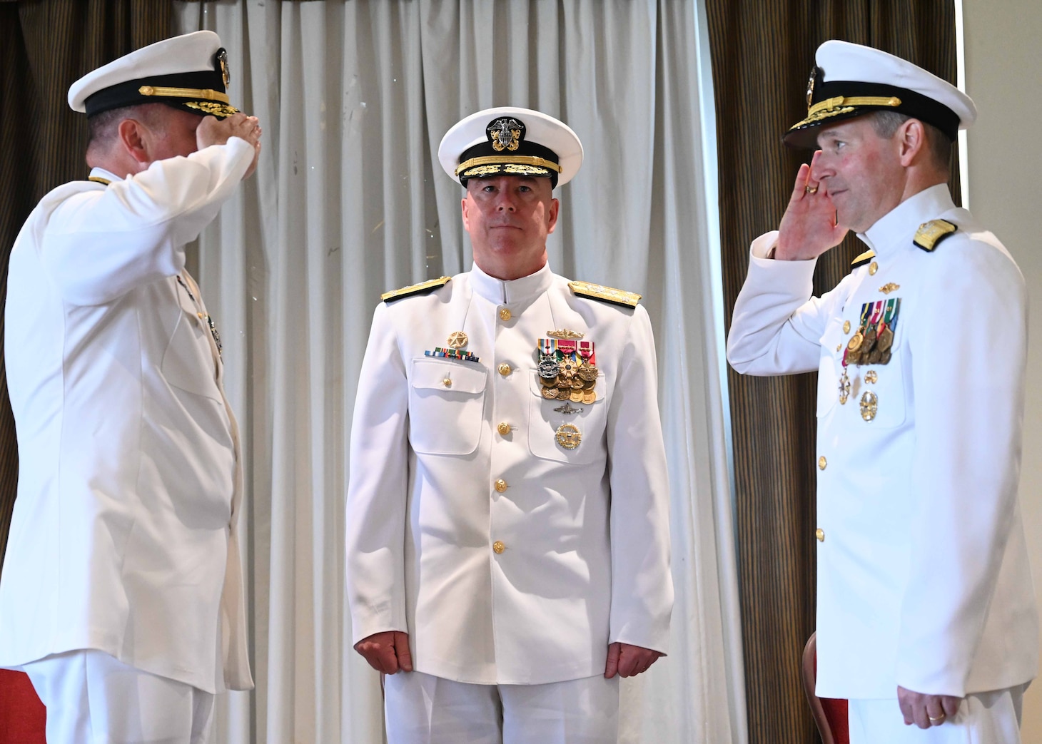 Rear Adm. Brian Davies, commander, Submarine Group Two (SUBGRUTWO), renders a salute during a change of command ceremony onboard Naval Station Norfolk.