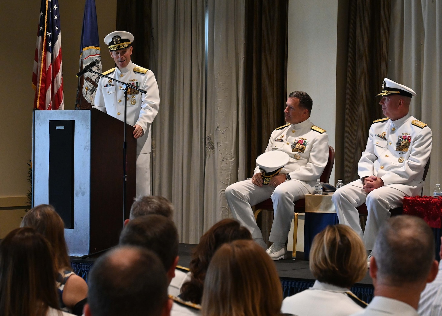Rear Adm. Brian Davies, commander, Submarine Group Two (SUBGRUTWO), reads his orders during a change of command ceremony onboard Naval Station Norfolk.