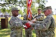 U.S. Army Maj. Hugh Carswell (left), the battalion executive officer for the 787th Combat Sustainment Support Battalion, and Command Sgt. Maj. Clint Halstead prepare to case the unit colors during a farewell ceremony June 3, 2023, at its headquarters in Dothan, Ala. The Reserve unit is deploying overseas to support Operation European Assure, Deter, Reinforce. (U.S. Army photo by Master Sgt. Gary A. Witte, 642nd Regional Support Group)