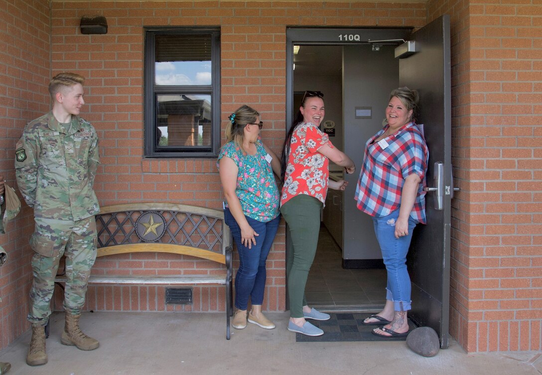 Members of the Dorm Council pose during the opening of the new day room June 2, 2023, at Sheppard Air Force Base, Texas. The Sheppard Spouses Club donated $1,800 to support the new day room for permanent party service members. (U.S. Air Force photo by Airman 1st Class Katie McKee)