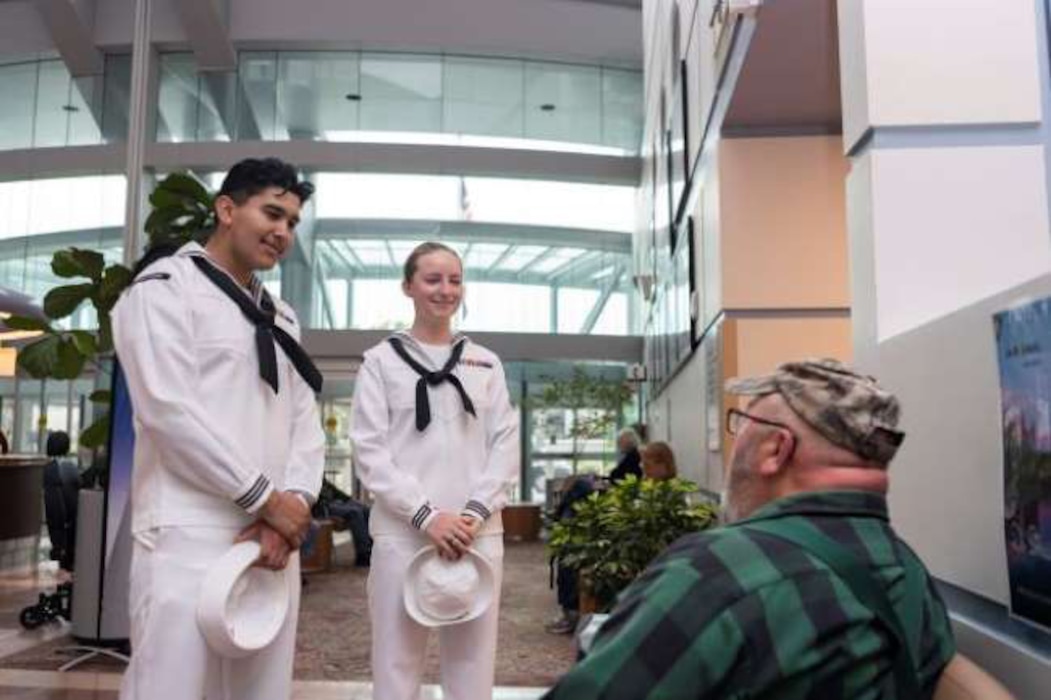 Damage Controlman 3rd Class Sergio Viscarra and Damage Controlman 3rd Class Katelyn Bingaman, assigned to Arleigh Burke-class guided-missile destroyer, USS John S. McCain (DDG 56), speak to veterans at the Portland VA Medical Center in Portland, Oregon for the annual Rose Festival during Portland Fleet Week on June 9, 2023. Portland Fleet Week is a time-honored celebration of the sea services and provides an opportunity for the citizens of Oregon to meet Sailors, Marines and Coast Guardsmen, as well as witness firsthand the latest capabilities of today’s maritime services. (U.S. Navy photo by Mass Communication Specialist Seaman Sophia H. Bumps)