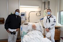 Personnel Specialist Chief Marquis Dallas and Logistics Specialist 1st Class Marcus Martin, assigned to Arleigh Burke-class guided-missile destroyer, USS John S. McCain (DDG 56), pose for a photo with a Navy veteran at the Portland VA Medical Center in Portland, Oregon for the annual Rose Festival during Portland Fleet Week on June 9, 2023. Portland Fleet Week is a time-honored celebration of the sea services and provides an opportunity for the citizens of Oregon to meet Sailors, Marines and Coast Guardsmen, as well as witness firsthand the latest capabilities of today’s maritime services. (U.S. Navy photo by Mass Communication Specialist Seaman Sophia H. Bumps)