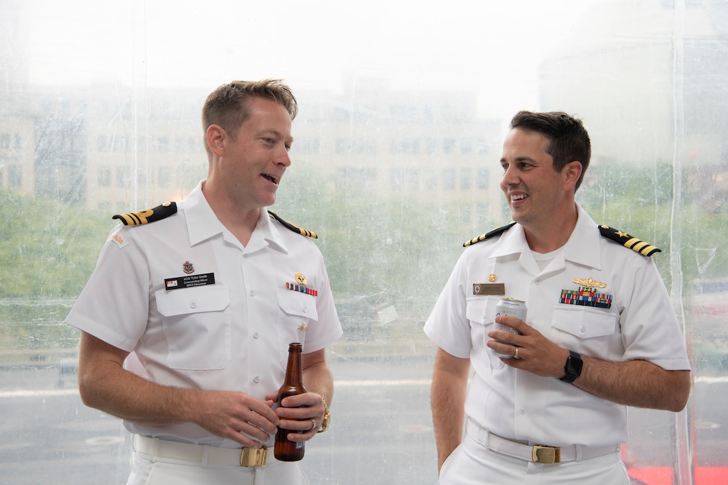 Lt. Cmdr. Tyler Smith, commanding officer, assigned to Royal Canadian Navy Kingston-class coastal defense vessel, HMCS Edmonton, speaks with Cmdr. Joseph Gunta, commanding officer, assigned to Arleigh Burke-class guided-missile destroyer, USS John S. McCain (DDG 56), at an U.S. Navy reception during Portland Fleet Week in Portland, Oregon, June 9, 2023. Portland Fleet Week is a time-honored celebration of the sea services and provides an opportunity for the citizens of Oregon to meet Sailors, Marines and Coast Guardsmen, as well as witness firsthand the latest capabilities of today’s maritime services. (U.S. Navy photo by Mass Communication Specialist Seaman Sophia H. Bumps)
